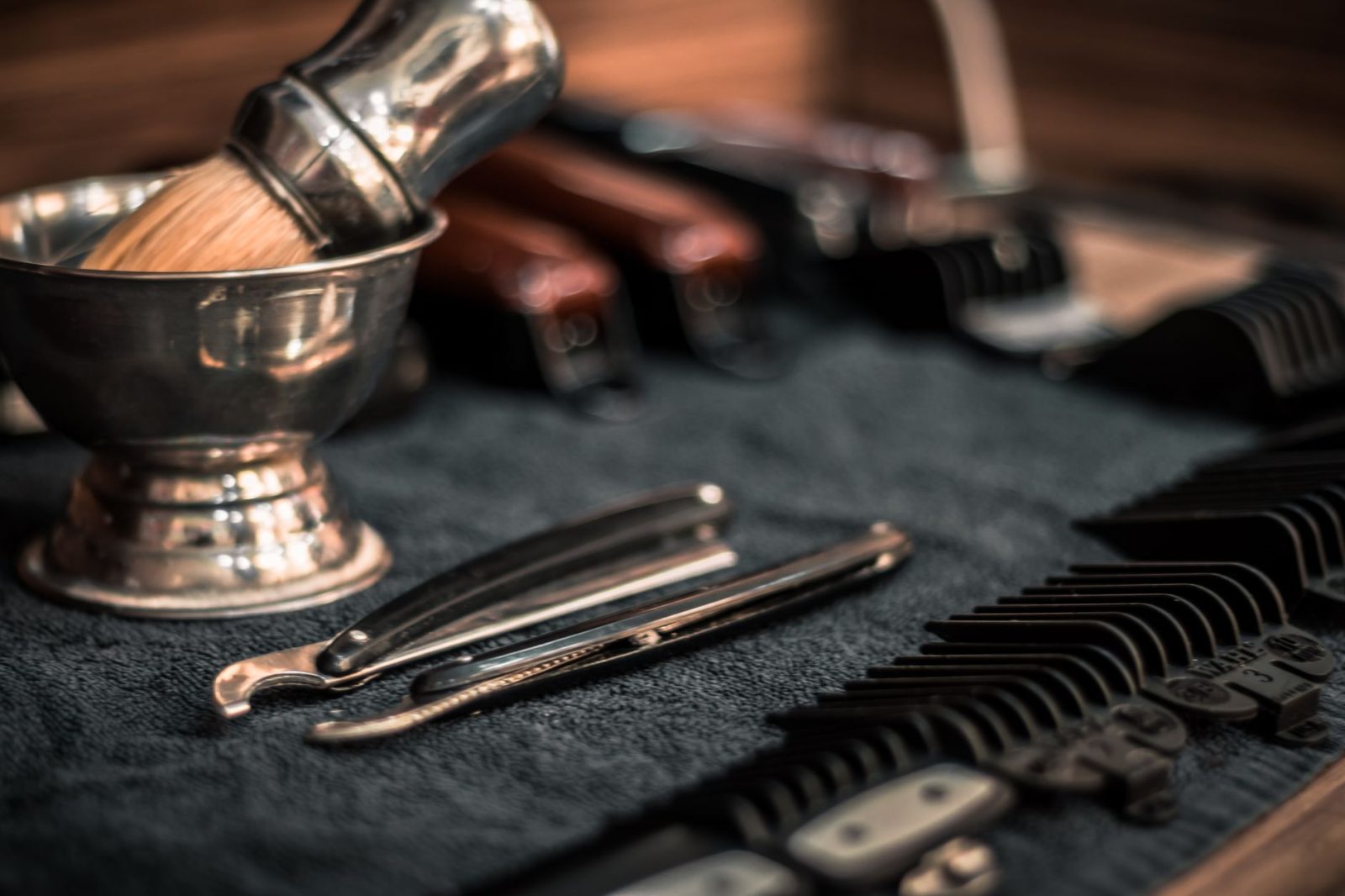 Close-up of neatly arranged barber tools including razors and combs